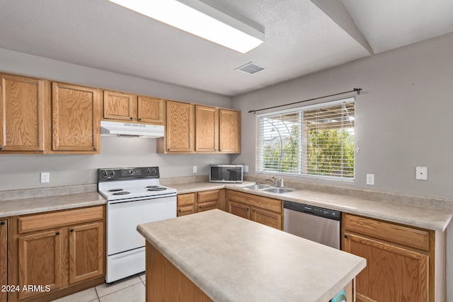 kitchen with sink, light tile patterned floors, and appliances with stainless steel finishes