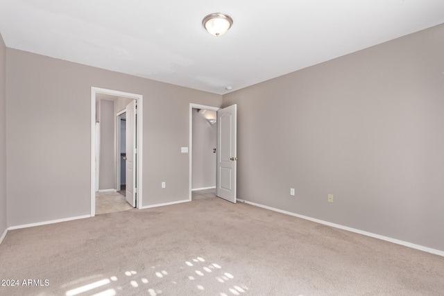 unfurnished bedroom featuring light colored carpet