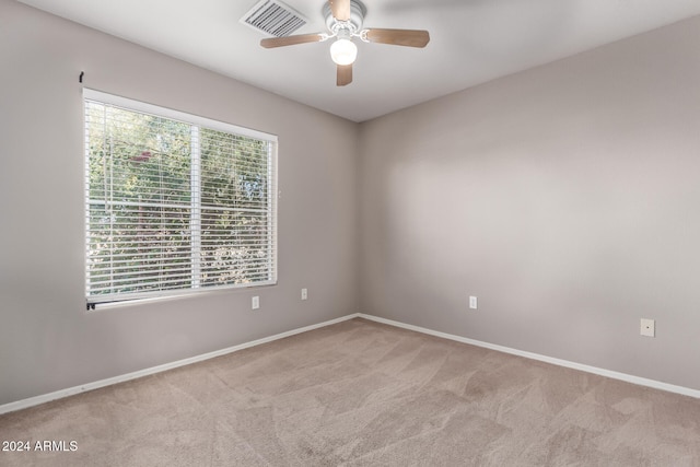 unfurnished room with ceiling fan and light colored carpet