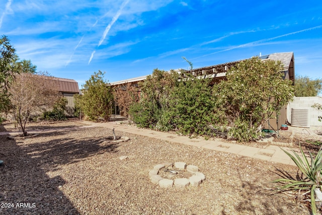 view of yard with an outdoor fire pit