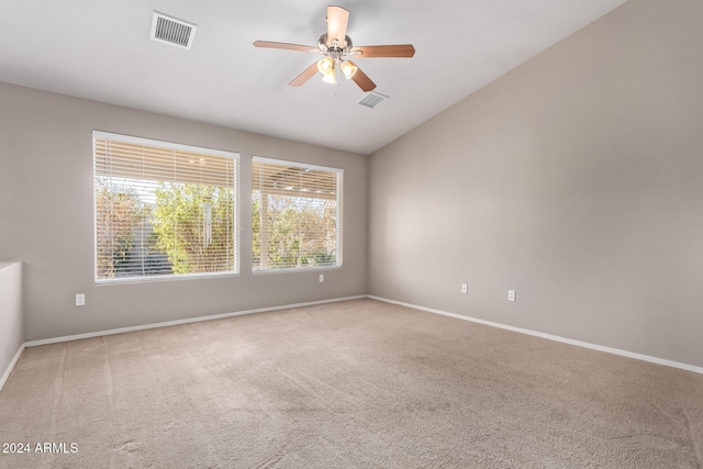 carpeted spare room with vaulted ceiling and ceiling fan