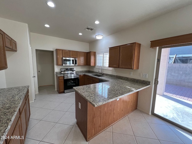 kitchen featuring light tile patterned floors, stainless steel appliances, sink, and kitchen peninsula