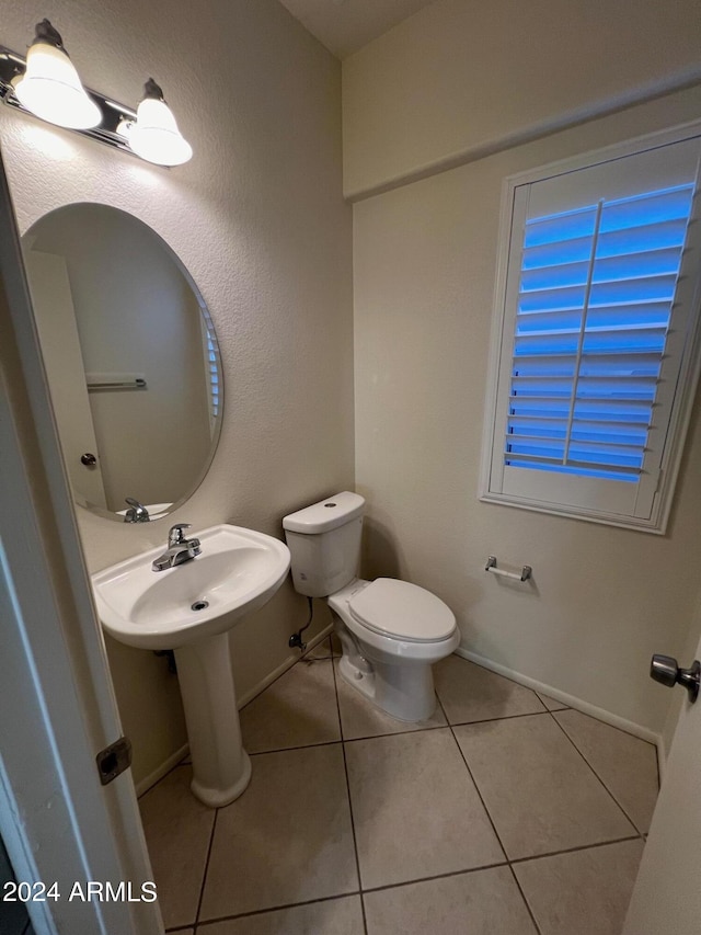 bathroom featuring toilet and tile patterned flooring