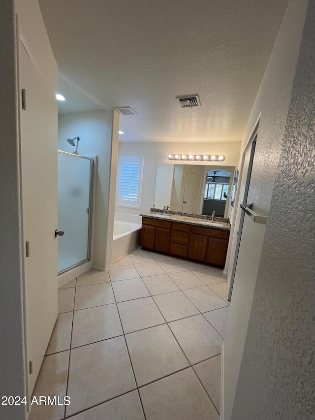 bathroom featuring vanity, a wealth of natural light, separate shower and tub, and tile patterned flooring