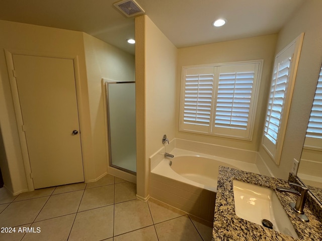 bathroom featuring vanity, plus walk in shower, and tile patterned floors