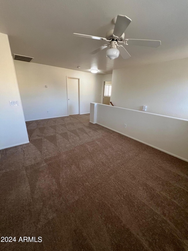 carpeted empty room featuring ceiling fan