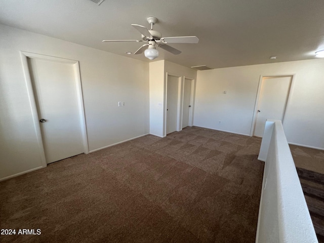 carpeted empty room featuring ceiling fan