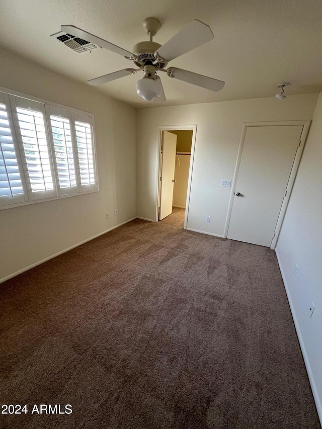 unfurnished bedroom featuring light colored carpet and ceiling fan