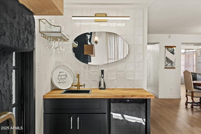 bar with wine cooler, dark hardwood / wood-style flooring, sink, backsplash, and butcher block countertops