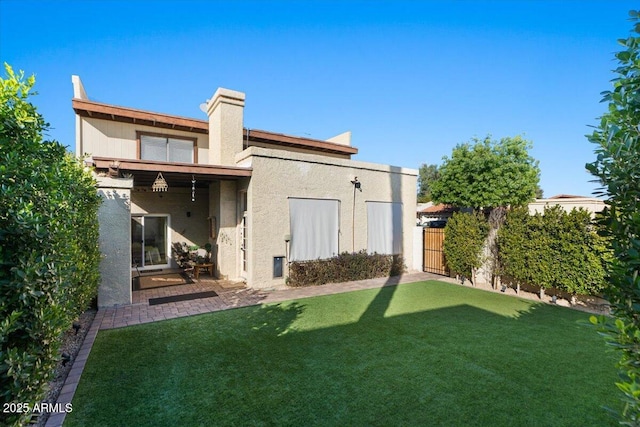 rear view of house featuring a lawn