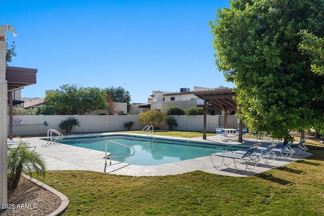 view of swimming pool with a yard and a patio