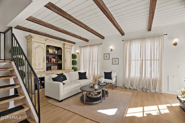 living room featuring wooden ceiling, lofted ceiling with beams, and light wood-type flooring