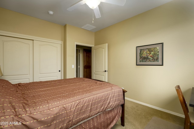 carpeted bedroom with a closet, visible vents, ceiling fan, and baseboards