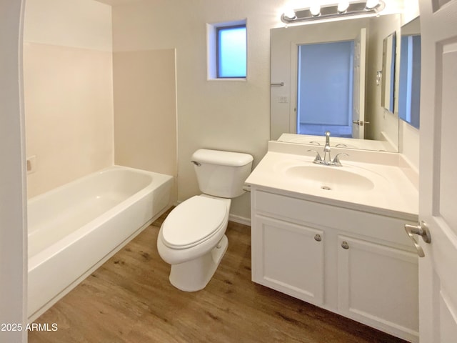 full bathroom with hardwood / wood-style flooring, shower / bathing tub combination, toilet, and vanity