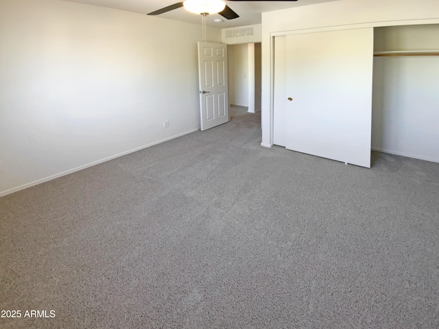 unfurnished bedroom featuring ceiling fan, a closet, and carpet flooring