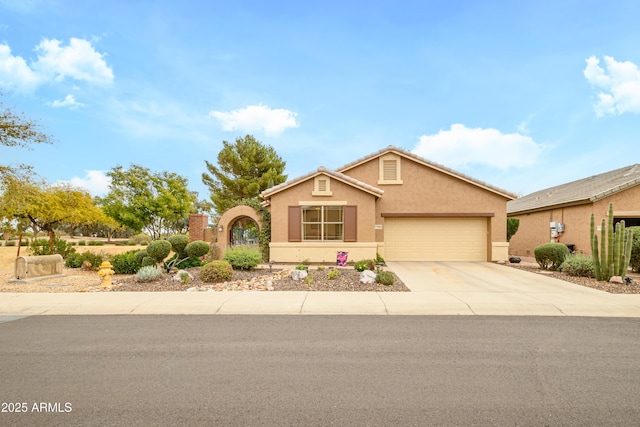 ranch-style home featuring a garage, concrete driveway, and stucco siding