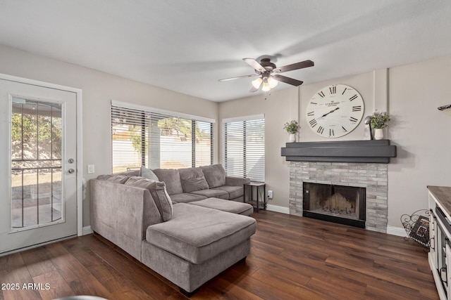 living area with dark wood-style floors, a fireplace, and baseboards