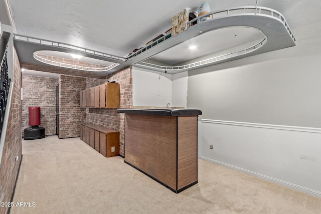 interior space featuring light colored carpet and brick wall