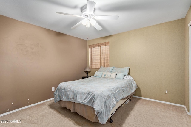 bedroom featuring light carpet, ceiling fan, and baseboards