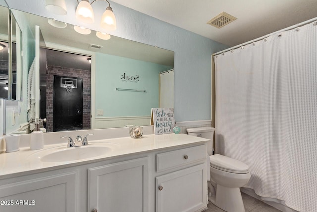 bathroom with toilet, tile patterned flooring, vanity, and visible vents