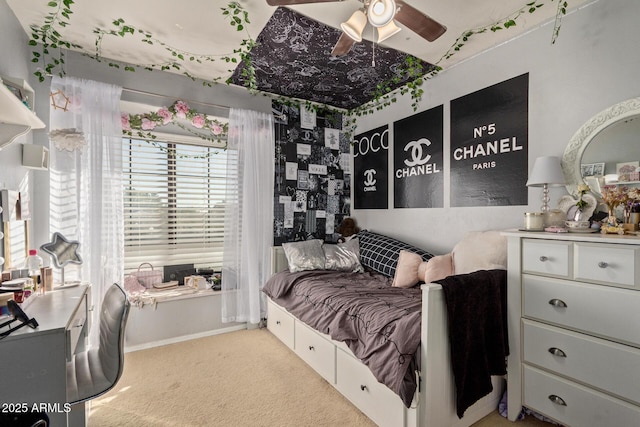 bedroom featuring ceiling fan and carpet