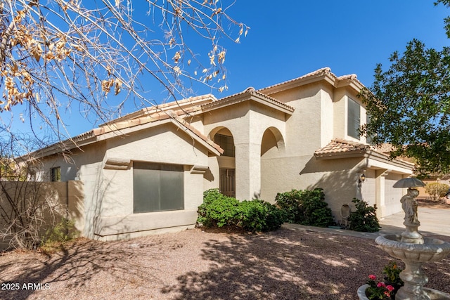 view of front of property featuring a tile roof and stucco siding