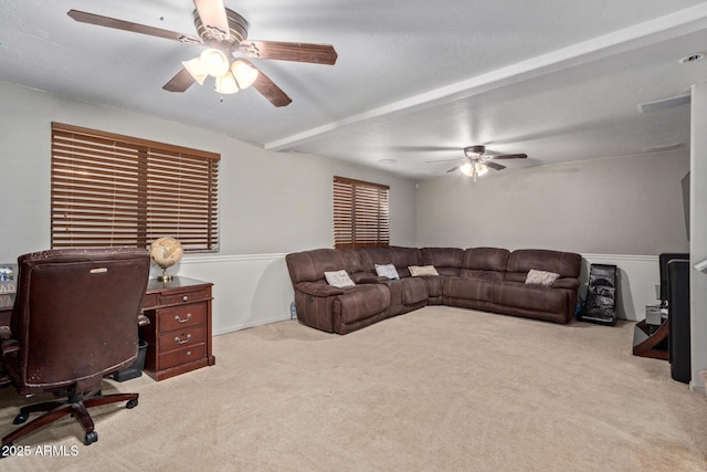 office space with ceiling fan, a wood stove, and light colored carpet