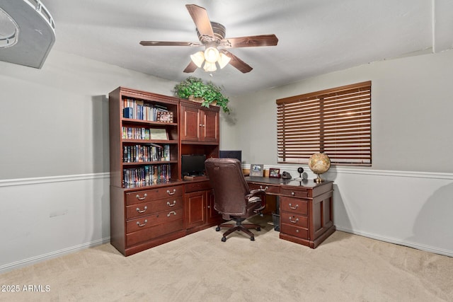 office with a ceiling fan and light colored carpet