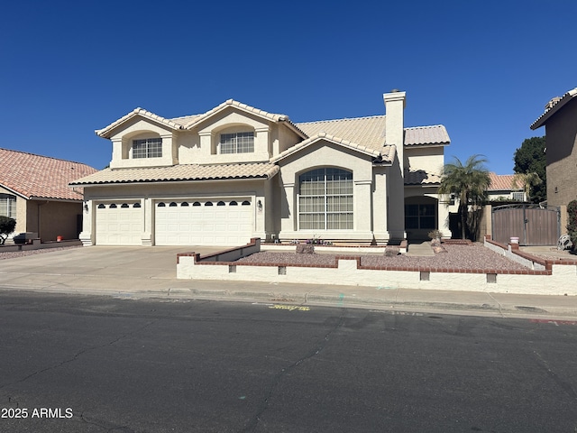 mediterranean / spanish-style home with driveway, a garage, a chimney, a tiled roof, and stucco siding