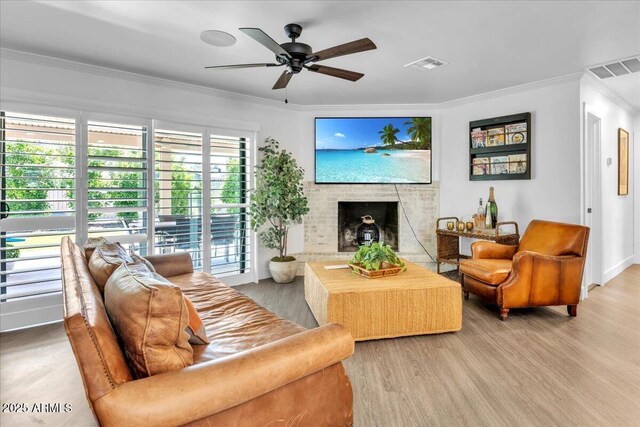 3505 N Miller Rd, Scottsdale, AZ 85251 - living area featuring crown molding, a fireplace, wood finished floors, a ceiling fan, and baseboards