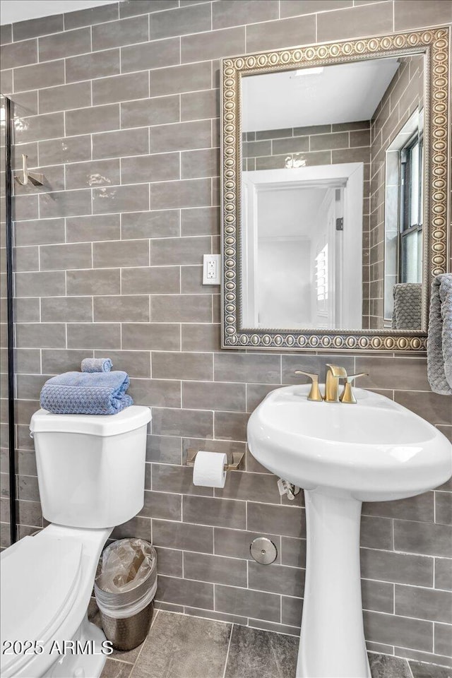 3505 N Miller Rd, Scottsdale, AZ 85251 - bathroom featuring toilet, tile walls, and a sink