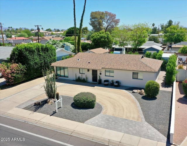 3505 N Miller Rd, Scottsdale, AZ 85251 - single story home featuring curved driveway, stucco siding, a residential view, and roof with shingles