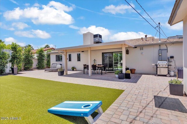 3505 N Miller Rd, Scottsdale, AZ 85251 - back of property with stucco siding, a patio area, a lawn, and a chimney