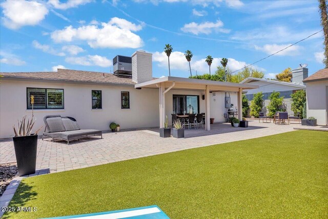 3505 N Miller Rd, Scottsdale, AZ 85251 - rear view of house with a chimney, a yard, a patio area, and stucco siding