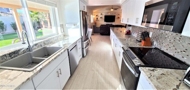 4617 E Emile Zola Ave, Phoenix, AZ 85032 - kitchen featuring appliances with stainless steel finishes, decorative backsplash, white cabinets, and ceiling fan