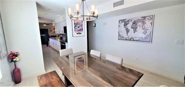 4617 E Emile Zola Ave, Phoenix, AZ 85032 - dining room featuring a chandelier and light wood-style floors