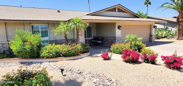 4617 E Emile Zola Ave, Phoenix, AZ 85032 - ranch-style house featuring stone siding, an attached garage, stucco siding, driveway, and a shingled roof