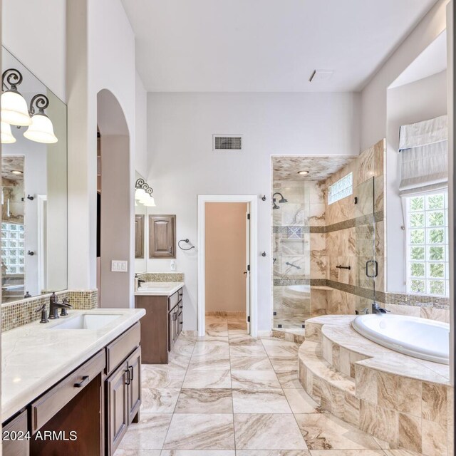 7101 E Berneil Ln, Paradise Valley, AZ 85253 - full bathroom featuring a shower stall, a garden tub, marble finish floors, two vanities, and a towering ceiling