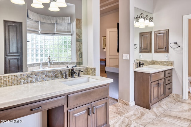 bathroom with a shower, vanity, and tasteful backsplash