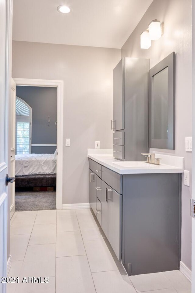 7101 E Berneil Ln, Paradise Valley, AZ 85253 - full bath featuring double vanity, baseboards, tile patterned flooring, ensuite bath, and recessed lighting