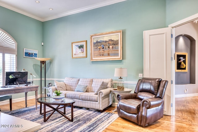 living room with light wood-type flooring and crown molding