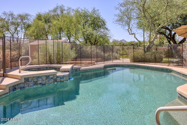 view of pool with an in ground hot tub