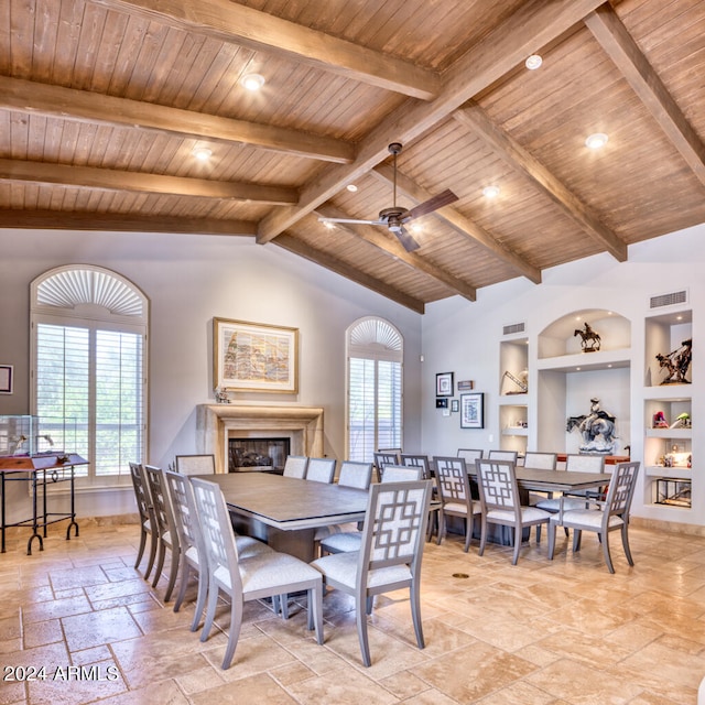 dining area with built in shelves, vaulted ceiling with beams, wood ceiling, and ceiling fan