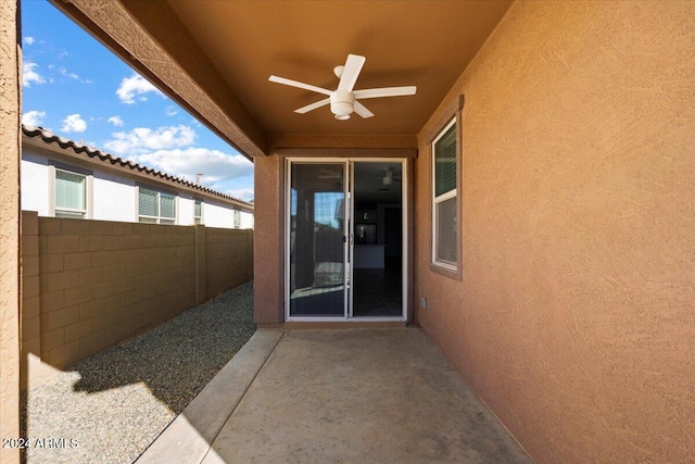 entrance to property featuring a patio and ceiling fan