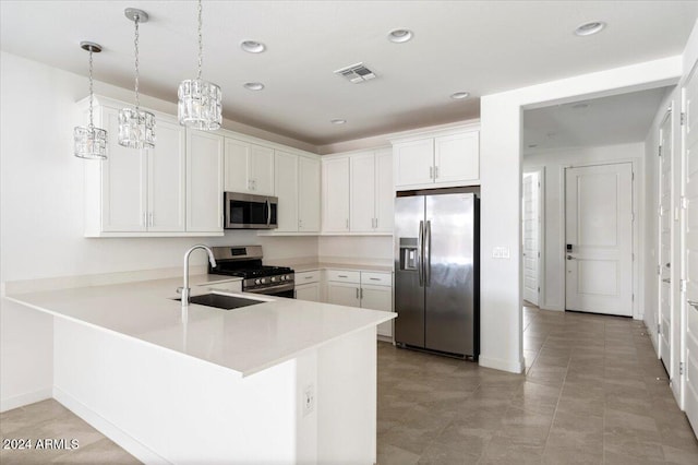 kitchen with white cabinets, decorative light fixtures, stainless steel appliances, and kitchen peninsula