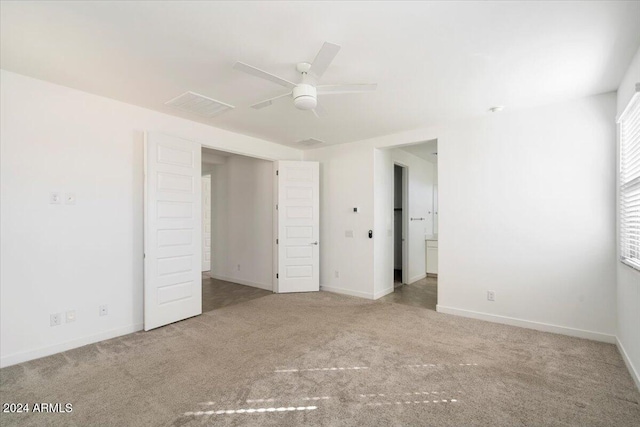 spare room with ceiling fan and carpet