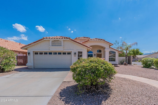 mediterranean / spanish-style house with a garage