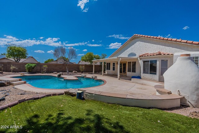 view of pool with a patio area, a diving board, and a lawn