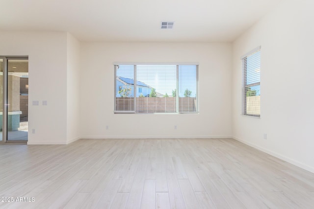 spare room with a healthy amount of sunlight and light wood-type flooring