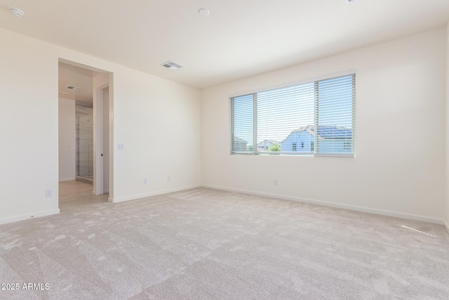 spare room with light colored carpet